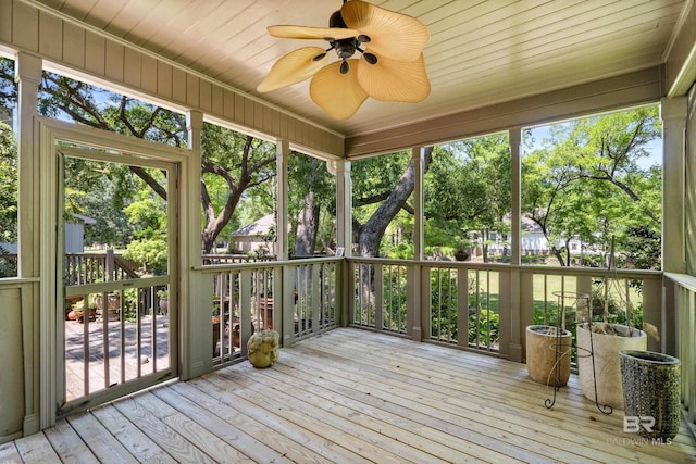unfurnished sunroom with ceiling fan