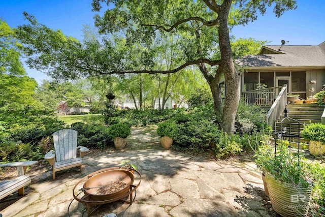 view of patio featuring a sunroom