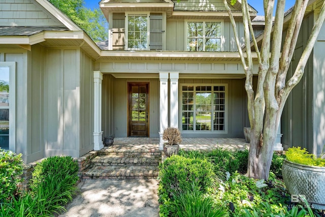 view of exterior entry with covered porch