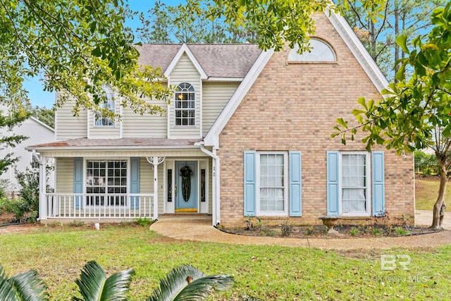 view of front of home featuring a front lawn and covered porch