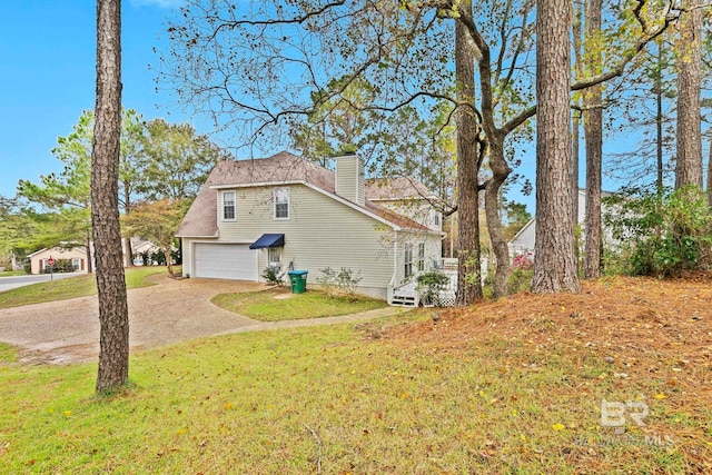 view of side of property featuring a yard and a garage