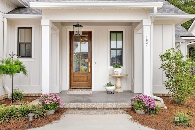 view of exterior entry with a porch