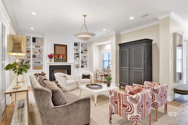 living room with ornamental molding, a healthy amount of sunlight, built in features, and hardwood / wood-style flooring