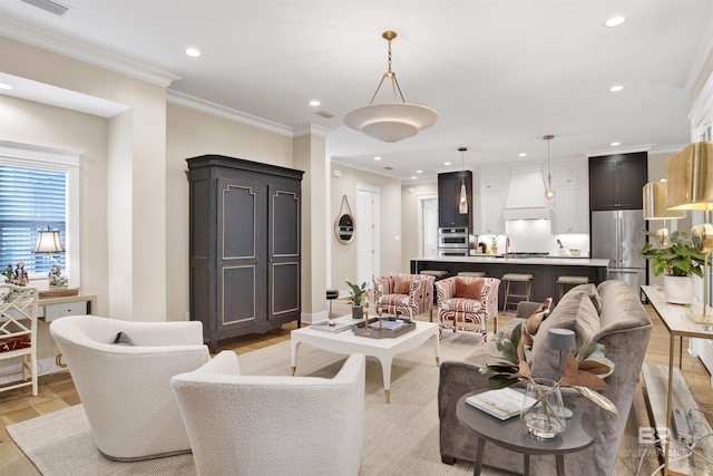 living room with crown molding and light hardwood / wood-style flooring