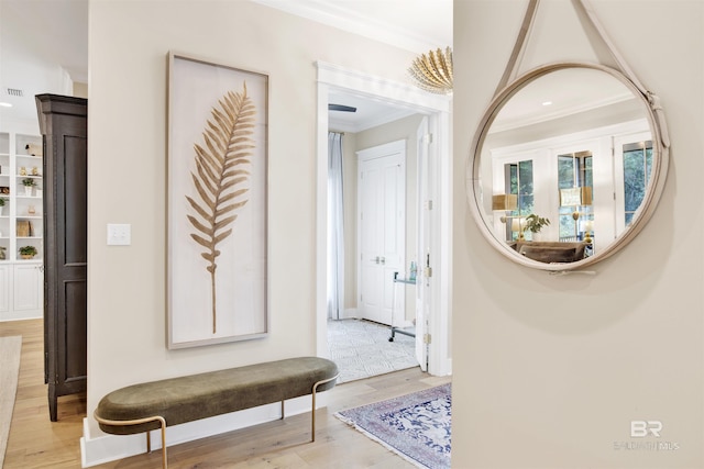 hallway featuring light hardwood / wood-style floors and crown molding