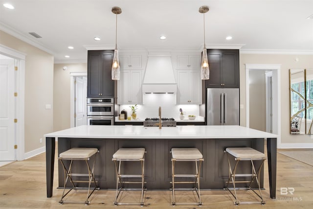 kitchen featuring a large island, light hardwood / wood-style flooring, a kitchen bar, custom range hood, and appliances with stainless steel finishes