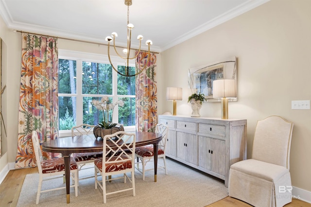 dining room featuring light hardwood / wood-style flooring, a wealth of natural light, crown molding, and a notable chandelier