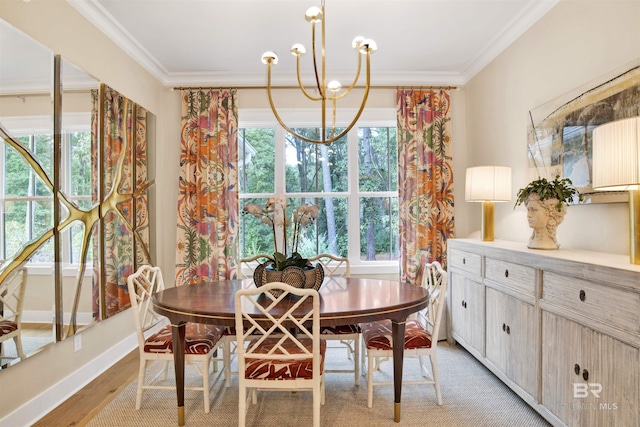 dining room with a notable chandelier, light hardwood / wood-style floors, a healthy amount of sunlight, and crown molding