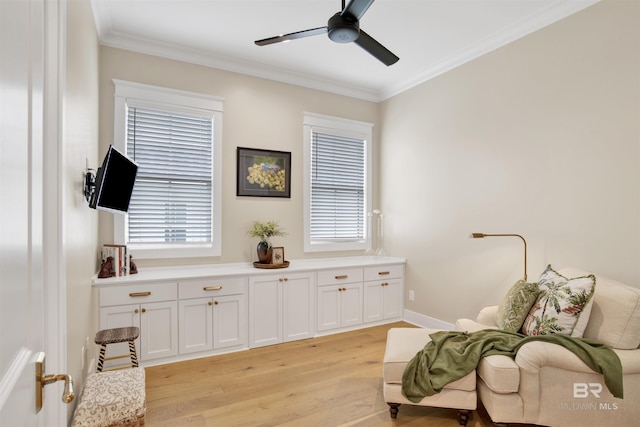 living area featuring light wood-type flooring, ceiling fan, and crown molding