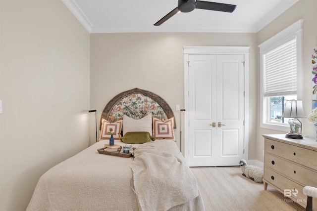 carpeted bedroom featuring a closet, ceiling fan, and crown molding