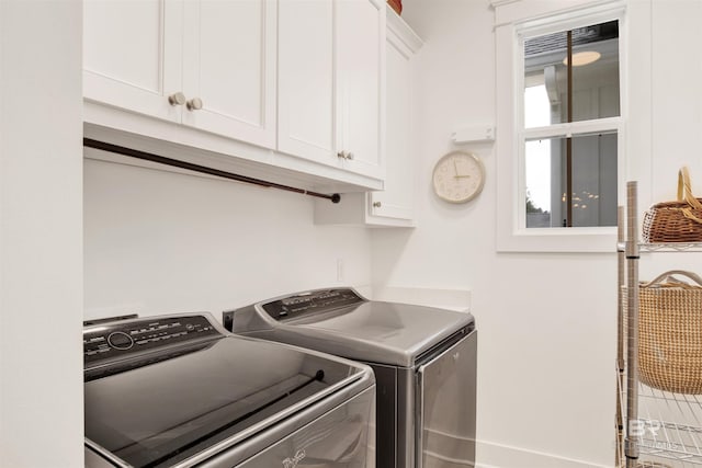 laundry room featuring washing machine and dryer and cabinets