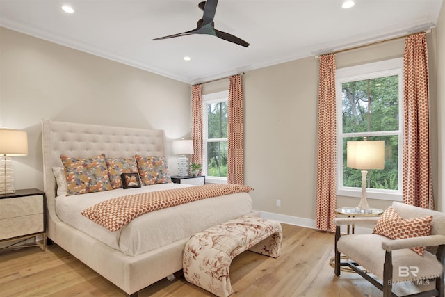 bedroom featuring multiple windows, light hardwood / wood-style floors, and ceiling fan