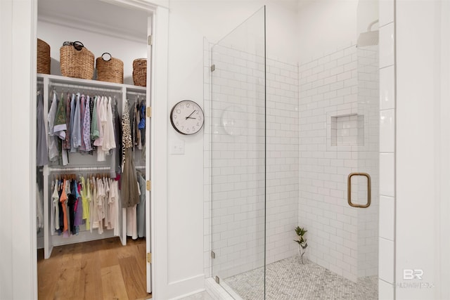 bathroom with wood-type flooring and walk in shower