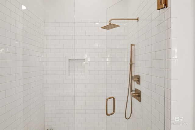 bathroom featuring a shower with door