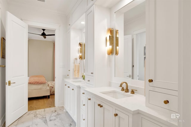 bathroom featuring ceiling fan, crown molding, vanity, and wood-type flooring