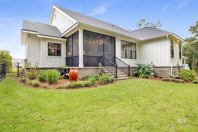 exterior space with a sunroom and a front lawn