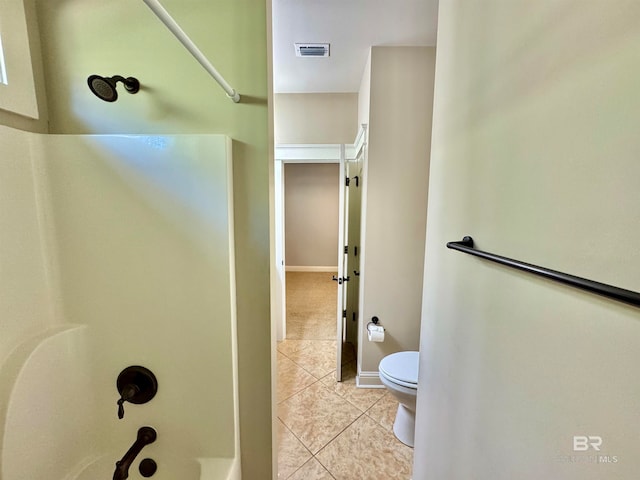 bathroom with toilet, a shower, and tile patterned flooring