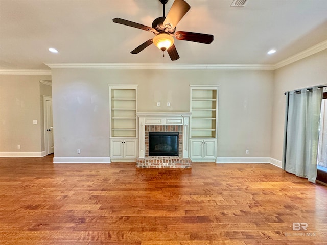 unfurnished living room with built in features, light hardwood / wood-style flooring, a fireplace, and ceiling fan