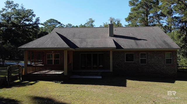 rear view of house with a lawn