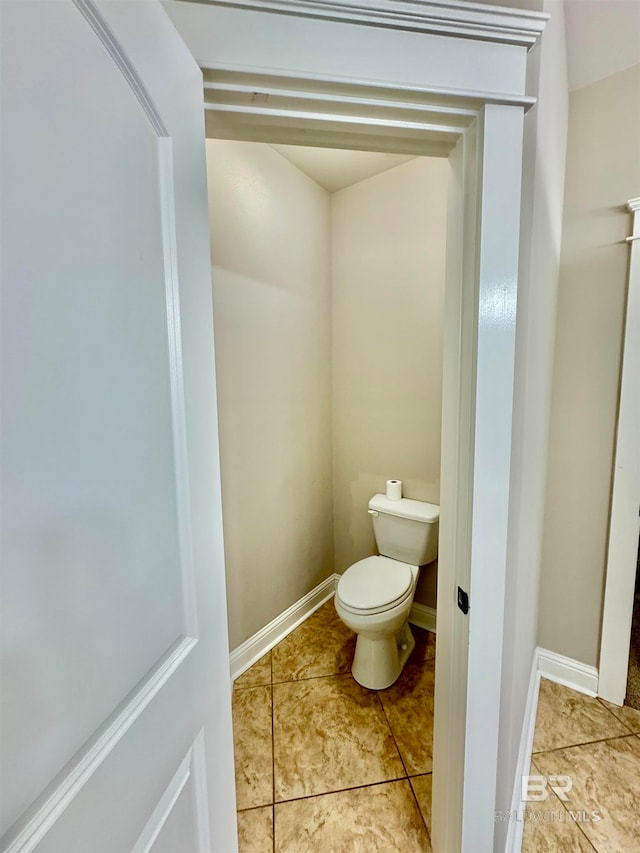 bathroom featuring toilet and tile patterned flooring