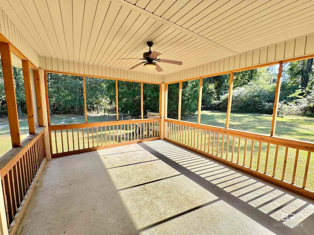 unfurnished sunroom featuring ceiling fan