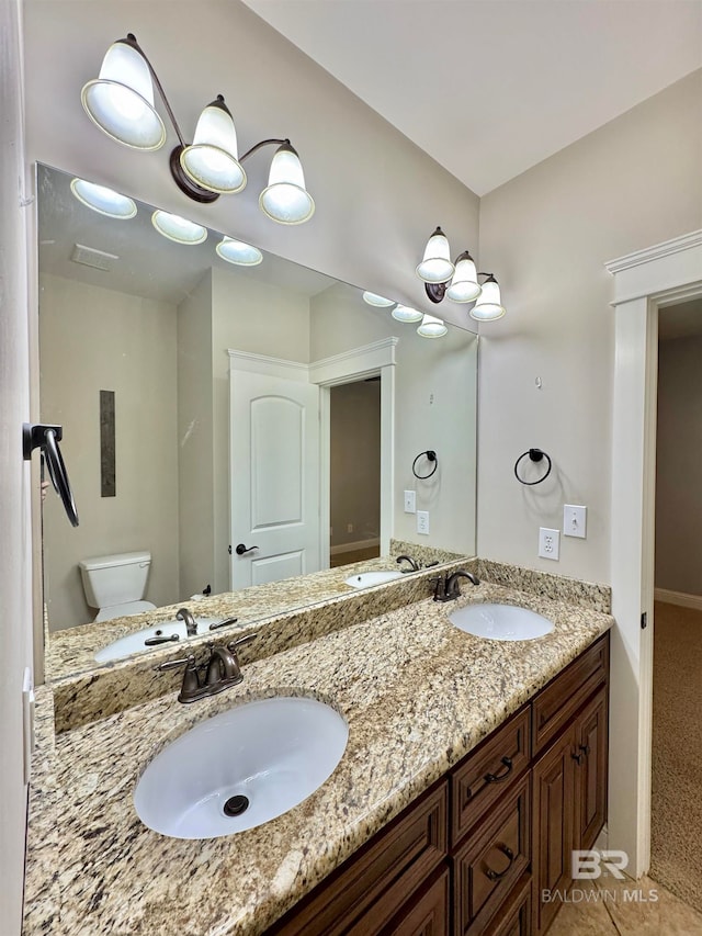 bathroom featuring vanity, toilet, and tile patterned flooring