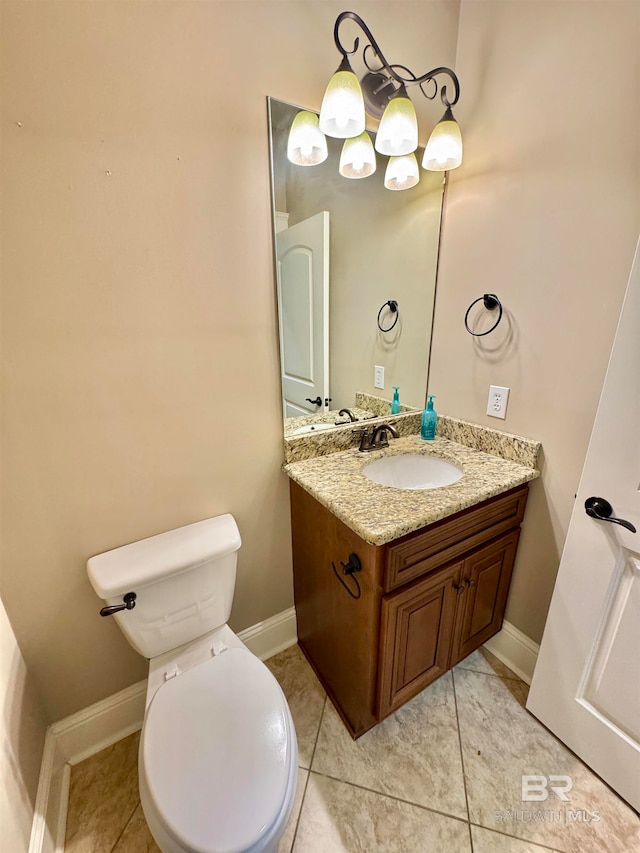 bathroom with vanity, toilet, and tile patterned floors