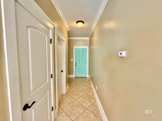 hallway with ornamental molding and light tile patterned floors