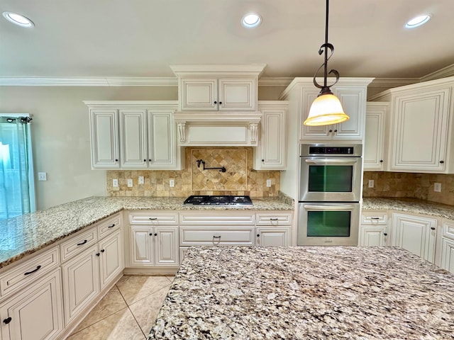 kitchen featuring crown molding, decorative light fixtures, stainless steel appliances, and light stone counters