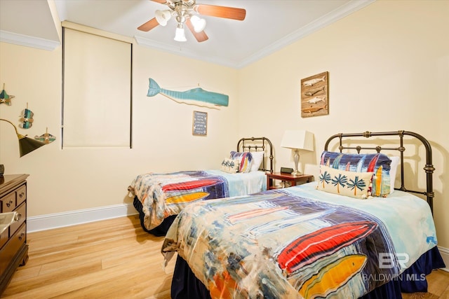 bedroom featuring ceiling fan, baseboards, crown molding, and wood finished floors