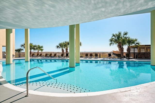 pool featuring a patio area and fence