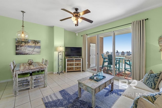 living room featuring tile patterned flooring, baseboards, and a ceiling fan