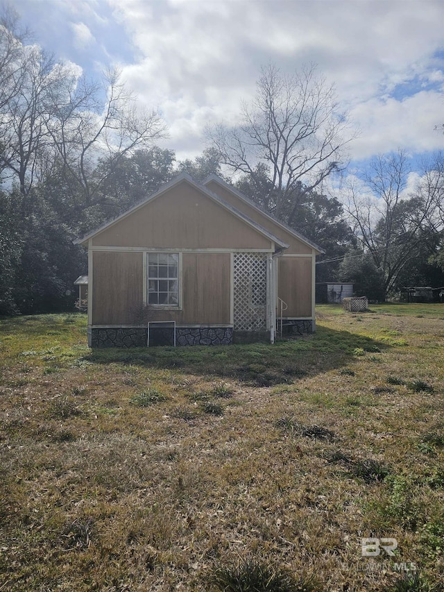 view of side of home with a yard