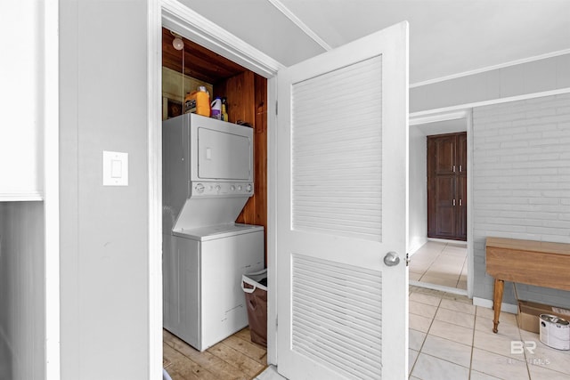 2774 N Grafhill Dr, Mobile, AL 36606 - laundry area with estacked washer and dryer, light tile patterned flooring, and brick wall