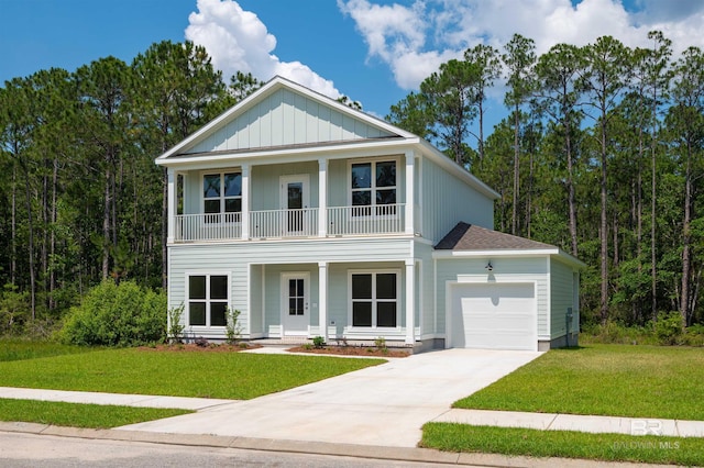 657 Island Way, Gulf Shores, AL 36542 - view of front of property with a balcony, a garage, a porch, concrete driveway, and a front lawn