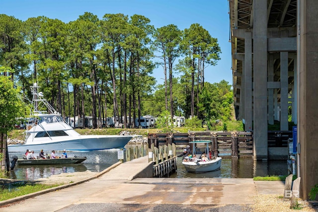 657 Island Way, Gulf Shores, AL 36542 - dock with a boat ramp, a water view, and view of wooded area