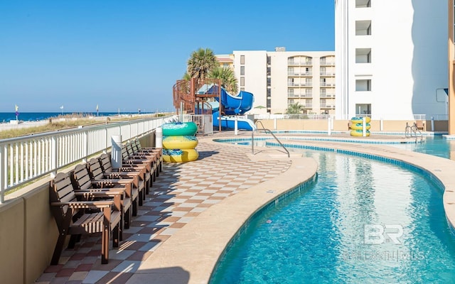 community pool featuring a water view and a water slide