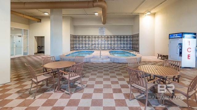 view of pool with a hot tub