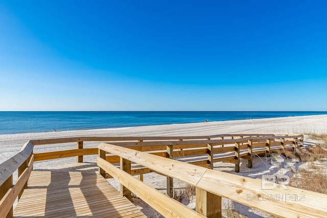 surrounding community with a water view and a view of the beach