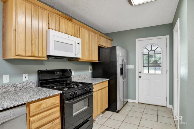 kitchen featuring light tile patterned floors, white appliances, light stone counters, and a textured ceiling