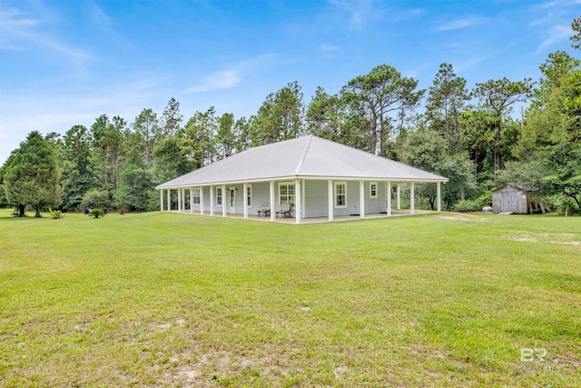 view of front facade with a front lawn, a storage unit, and a porch