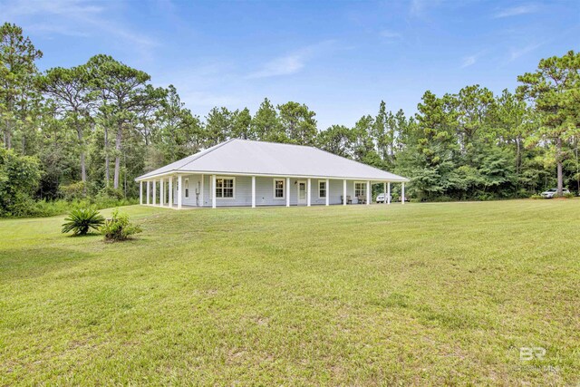 exterior space featuring covered porch and a front yard