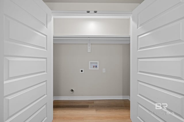 washroom featuring light wood-type flooring, washer hookup, electric dryer hookup, and baseboards