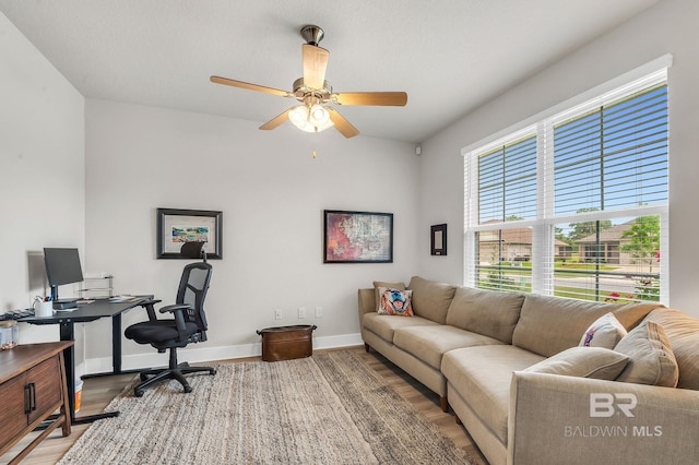 office with baseboards, a ceiling fan, and wood finished floors