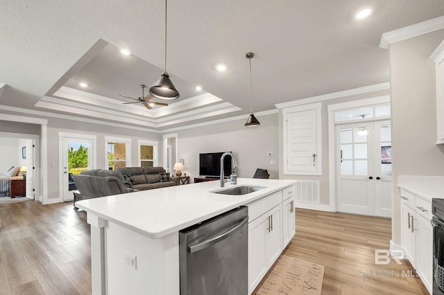 kitchen featuring ceiling fan, a sink, dishwasher, open floor plan, and ornamental molding