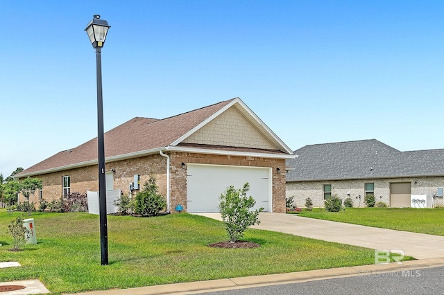 view of front facade with brick siding, a garage, a front lawn, and driveway