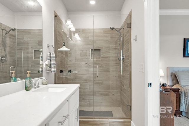 full bathroom featuring vanity, recessed lighting, a shower stall, and ensuite bath