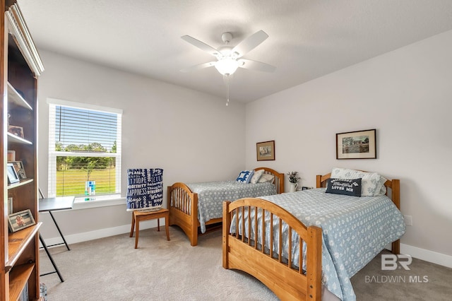 carpeted bedroom with baseboards and ceiling fan