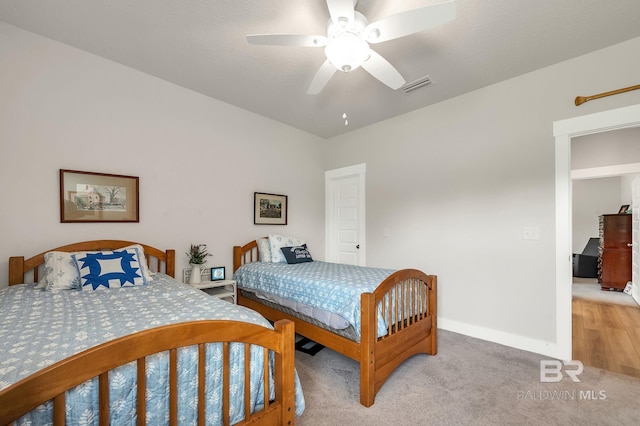 bedroom with baseboards, ceiling fan, light carpet, and visible vents