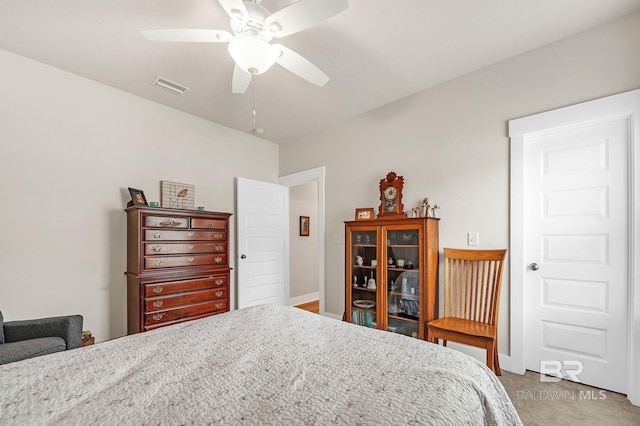 bedroom featuring baseboards, light carpet, a ceiling fan, and visible vents